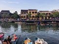 Mustard yellow building and boat on river at Hoi an ancient town, Vietnam