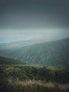 Scenery view from the top of the mountains to the ocean coastline in Hawaii, Oahu island. Moody hiking landscape with foggy, green Royalty Free Stock Photo