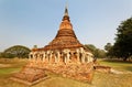 Scenery of Wat Sorasak, an ancient Buddhist Temple with elephant sculptures supporting the base of the stupa