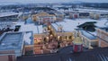 Scenery of winter city, fields, roards parking lot, buildings, snowing day.