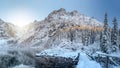 Scenery winter mountains. Amazing snowy rocks and icy lake. Beautiful view on High mountain covered by snow. Frosty nature