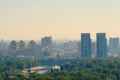 Scenic aerial cityscape of Kyiv in morning haze. Silhouettes of modern high-rise buildings at smog.