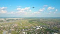 Scenic aerial shot of commercial airplane leaving an international airport Royalty Free Stock Photo