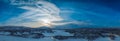 Scenic aerial Sunset panorama on frozen lake, mountains with snow mobile traces, northern green lights over mountains Royalty Free Stock Photo