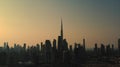 Scenic aerial sunset view of a big modern city timelapse, skyscrapers, office buildings and burj al arab silhouette on Royalty Free Stock Photo