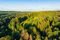 Scenic aerial view of Stirniai mound surrounded with green trees, located in Neris Regional Park near Vilnius, Lithuania, on sunny