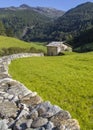 Scenic alpine meadow, hut an mountains