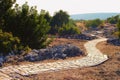 Scenic ancient winding cobble stone pathway along the ruins of antique buildings