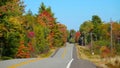 Scenic asphalt road running up and down and through the colorful deciduous trees Royalty Free Stock Photo