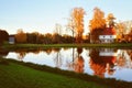 Scenic autumn landscape with a cottage surrounding by golden trees and beautiful lake Royalty Free Stock Photo