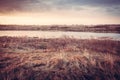 Scenic autumn landscape during dawn at river bank in rural field Royalty Free Stock Photo