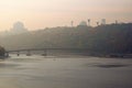 Scenic autumn landscape of Dnipro River with embankment, River Port and Pedestrian Bridge. Foggy morning