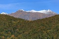 Scenic autumn landscape of Main Caucasus ridge with snowy mountain peak tops on blue sky background Royalty Free Stock Photo