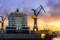 Scenic back view large modern luxury cruise ship liner under construction building cranes at dry dock shipyard in Royalty Free Stock Photo