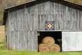 Scenic barn with hay bales and quilt design.