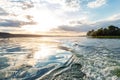 Scenic bright vibrant blue to red warm sunset evening time landscape with motorboat swirl trace on water surface of lake Royalty Free Stock Photo