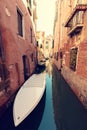 Scenic canal with boat in Venice, Italy