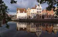 Scenic city view of Bruges canal with beautiful medieval colored houses, bridge and reflections at sunny day. Royalty Free Stock Photo