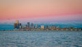 Scenic cityscape of Detroit with a pink sunset sky and waterscape