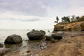 Scenic cliff with sundstone layers. the boulders on shore of Baltic sea. Summer storm time.