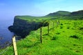 Scenic cliffs of the Causeway Coast, Northern Ireland with light early morning fog