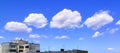 Scenic Clouds on Deep Blue Sky Background over Rustic Apartment Building of Concrete Panels on a Bright Summer Day