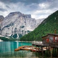 Small wooden boats moored at the shore on the background of a majestic mountain