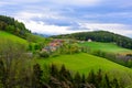 Idyllic lovely green rural agricultural countryside with meadow, trees, forest, hills Royalty Free Stock Photo