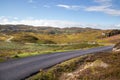 Scenic country road winding through a picturesque valley full of greenery in Drumbeg, Scotland Royalty Free Stock Photo