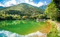 Scenic crescent moon lake pool view with Cangshan mountain water reflection in the Butterfly spring park Dali Yunnan China