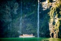 Scenic cruise approaches waterfall, Milford Sound. Royalty Free Stock Photo