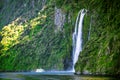 Scenic cruise approaches waterfall, Milford Sound. Royalty Free Stock Photo