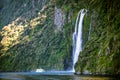 Scenic cruise approaches waterfall, Milford Sound. Royalty Free Stock Photo