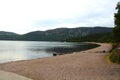 Scenic display of a shoreline against a view of seascape and green mountains