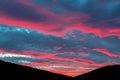 Scenic dramatic fiery cloudy sunset evening view over mountain resort village Bukovel in Ukraine with pine forest Royalty Free Stock Photo