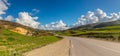 A Scenic Drive Through Mountains and Green Fields Under a Blue Sky with Clouds in Tunisia Royalty Free Stock Photo