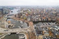 scenic drone shot of Amsterdam City center, canals with colorful houses, harbor and houses