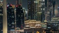 Scenic Dubai downtown skyline timelapse at night. Rooftop view of Sheikh Zayed road with numerous illuminated towers.