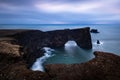 Scenic Dyrholaey rock formation at stormy cloudy morning on cold atlantic coast in iceland