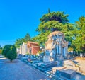 The scenic funeral tombs along the shaddy alley in Monumental Cemetery, on April 5 in Milan, Italy