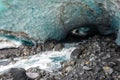 Scenic glacier ice caves with river flowing out from inside Royalty Free Stock Photo