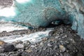 Scenic glacier ice caves with river flowing out from inside Royalty Free Stock Photo