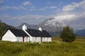 Scenic Glencoe with lovely white house - Croft in the scottish Highlands, Scotland Royalty Free Stock Photo