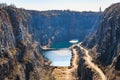 Scenic gorge with serene lake and rocky cliffs under clear sky Royalty Free Stock Photo