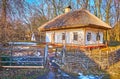 The scenic hata farmhouse amid the snowy swampy yard, Pyrohiv Skansen, Kyiv, Ukraine