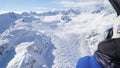 Scenic Helicopter ride over the Franz Josef Glacier and Fox Glacier with deep crevasses and snow during winter in New Zealand.