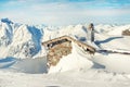 Scenic Highland alpine old abandoned stone hut with chimney snowbound by thick snow layer after blizzard. Mountain Royalty Free Stock Photo