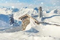 Scenic Highland alpine old abandoned stone hut with chimney snowbound by thick snow layer after blizzard. Mountain Royalty Free Stock Photo