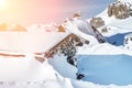 Scenic Highland alpine old abandoned stone hut with chimney snowbound by thick snow layer after blizzard. Mountain Royalty Free Stock Photo