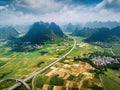 Scenic highway in Guangxi province of China surrounded with rice fields and rocks Royalty Free Stock Photo